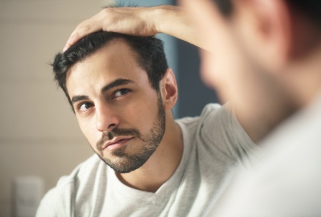 storyblocks-latino-person-with-beard-grooming-in-bathroom-at-home-white-metrosexual-man-worried-for-hair-loss-and-looking-at-mirror-his-receding-hairline_H8mcRKLWQ
